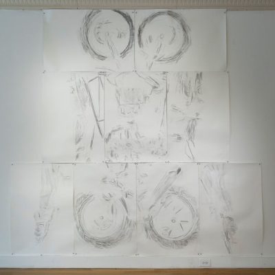 Multiple pieces of paper put together to create an abstracted illustration from a graphite rubbing